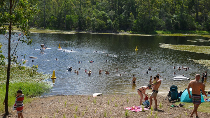 swimming hole with people around the banks